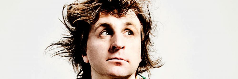 Head shot of Milton Jones looking up to the left.